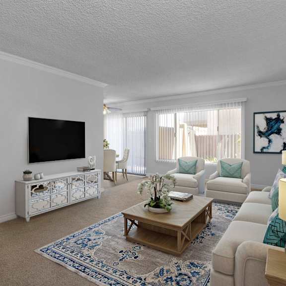 a living room with a white couch, a coffee table, and a television.