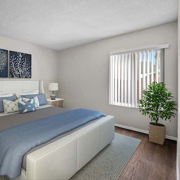 a bedroom with a bed, nightstands, and a plant.