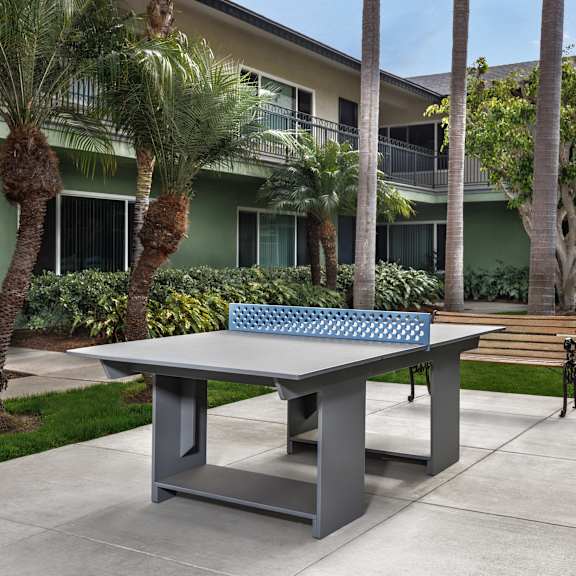 a grey table with a blue and white table cloth on it.