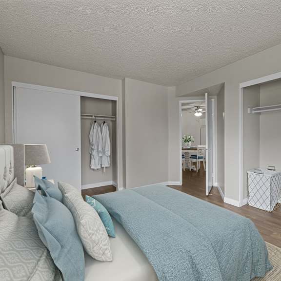a bedroom with a bed and a lamp.