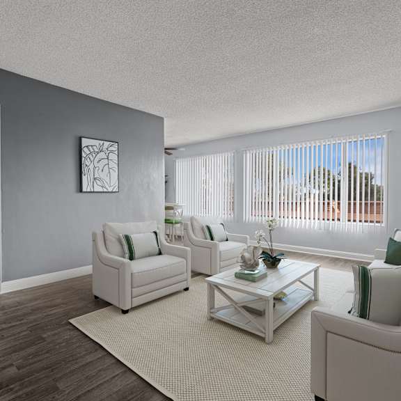 a living room with a white sofa and a coffee table.