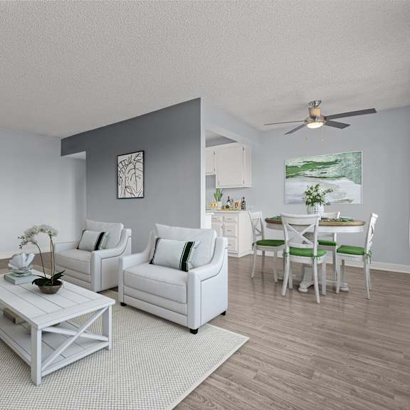a living room with white furniture and a ceiling fan.