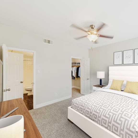 a bedroom with a large bed and a ceiling fan.