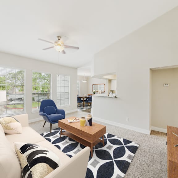a living room with a white couch and a blue chair.