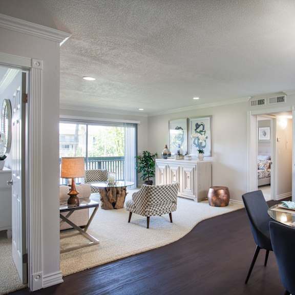 a modern living and dining room with a large table and chairs.