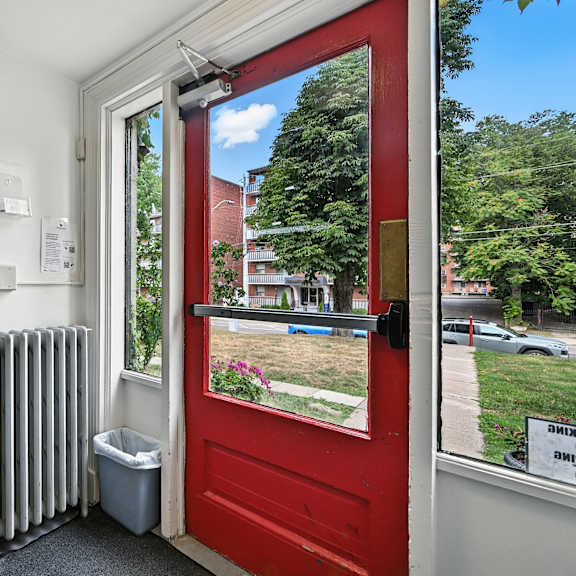a red door with a window on the other side.
