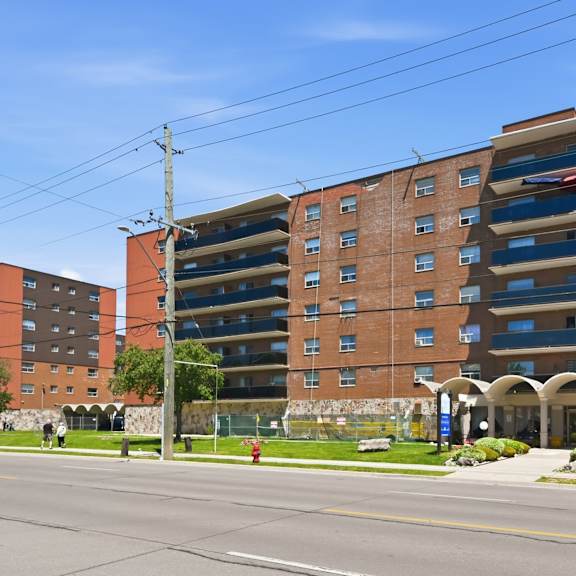 a large brick building with a parking garage on the top floor.