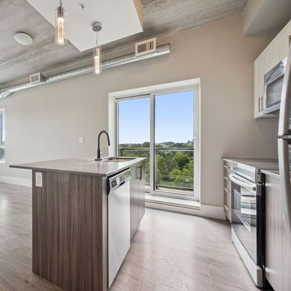 a kitchen with a large island and stainless steel appliances.