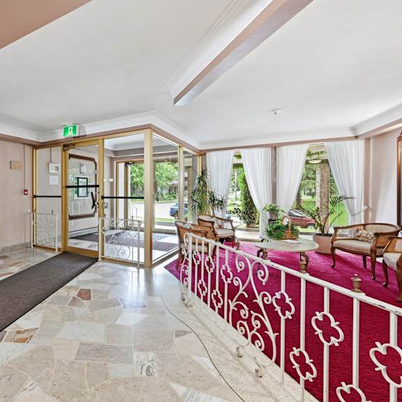 a hallway with a red and white patterned railing.