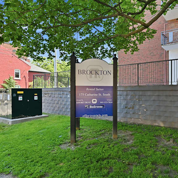 a sign for brockton is in front of a brick building.