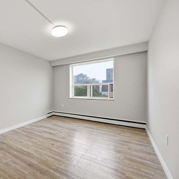 empty room with wooden floor and a window.