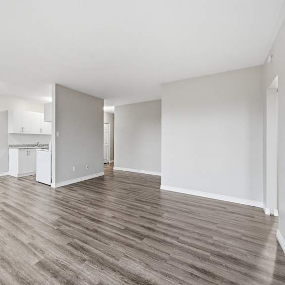 a room with wooden flooring and white walls.