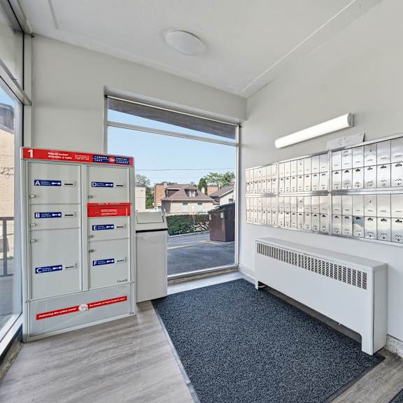a row of mailboxes are lined up on a wall.