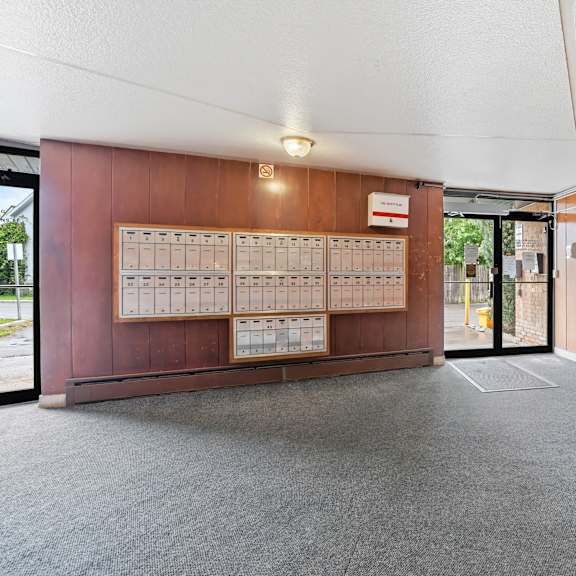 a room with a carpeted floor and a wooden wall with a calendar on it.