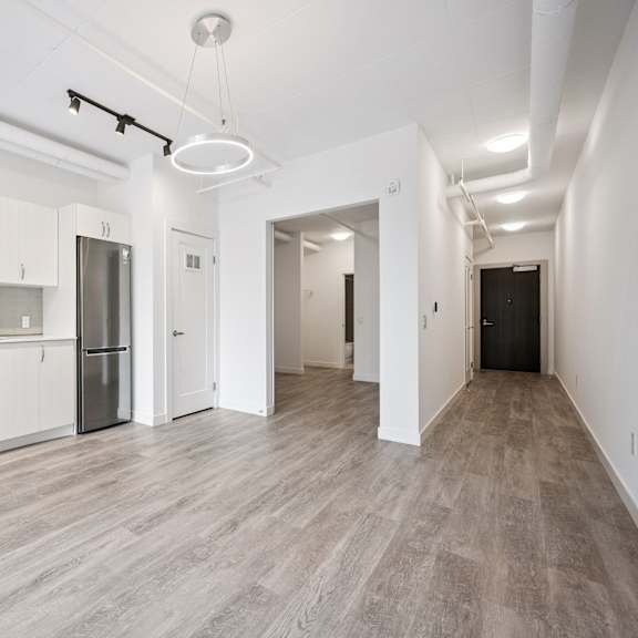 a modern kitchen with white cabinets and stainless steel appliances.