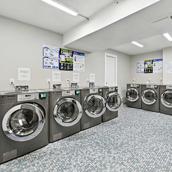 a laundromat with rows of washing machines.