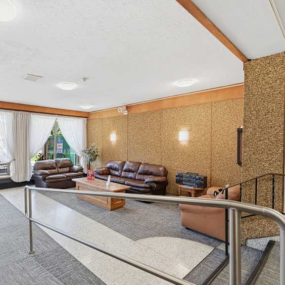 a living room with a couch, chairs, and a coffee table.