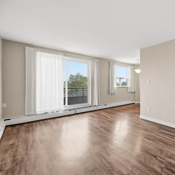 a room with wooden floors and white walls.