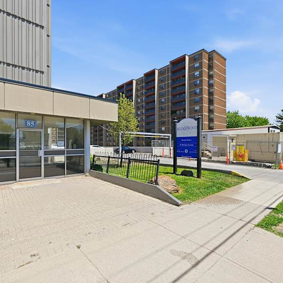 a building with a blue sign that says "857" is in the background.