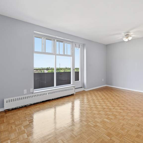 a room with a large window and a radiator on the floor.