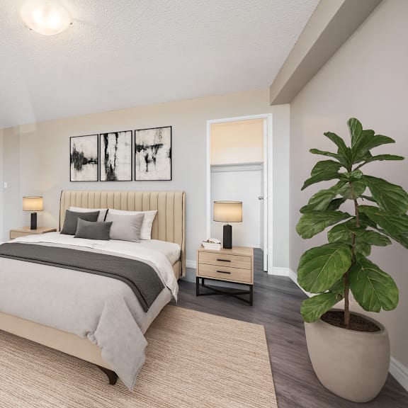 a bedroom with a large bed and a plant on the side table.