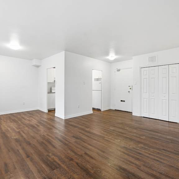 a room with wooden floors and white walls.