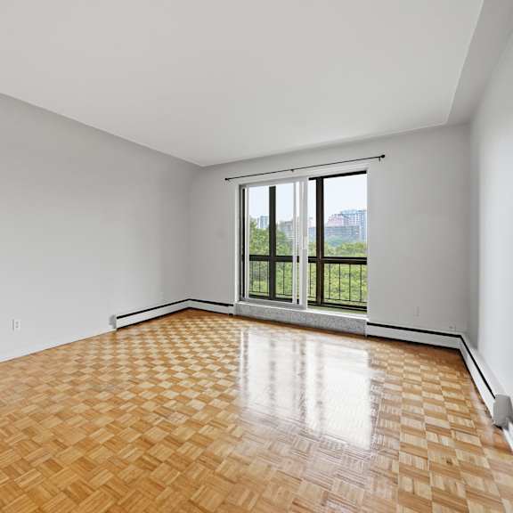 a room with a wooden floor and a sliding glass door.