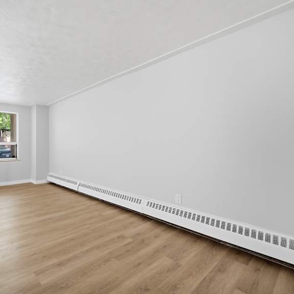 a room with wooden floors and white walls.