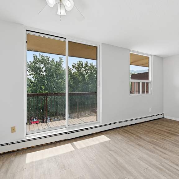 a room with a sliding glass door leading to a balcony.