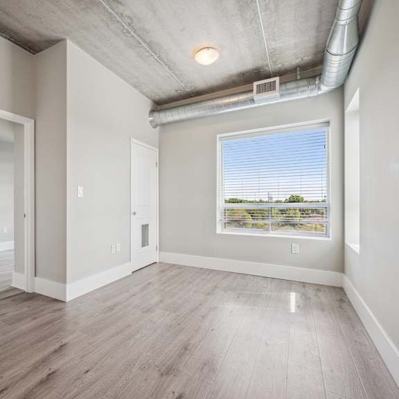 a room with a window and a view of a field.