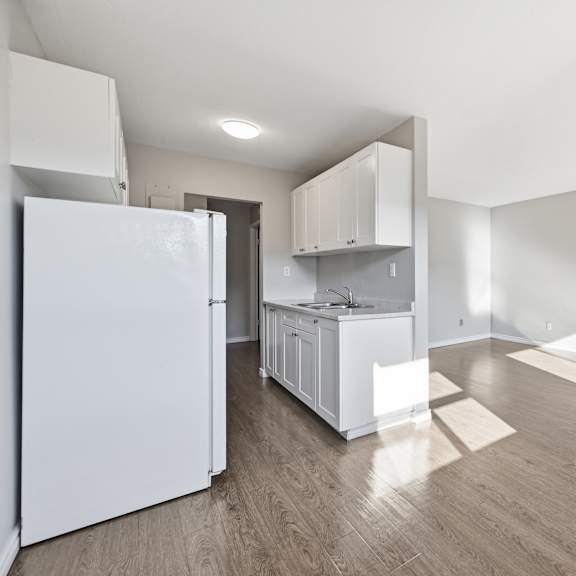 a kitchen with white appliances and cabinets is shown.