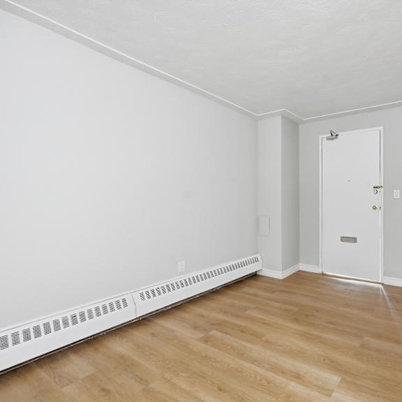 a room with a white door and a white wall.