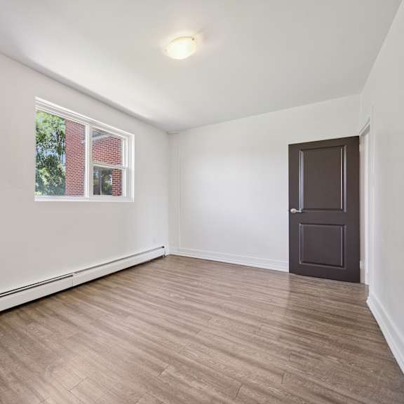 a room with a brown door and a window.