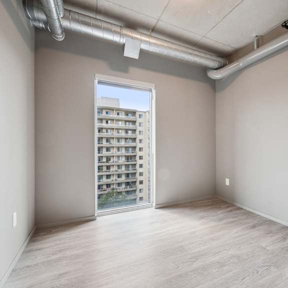 a room with a view of a building outside through a window.