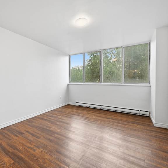 a room with wooden flooring and a window.