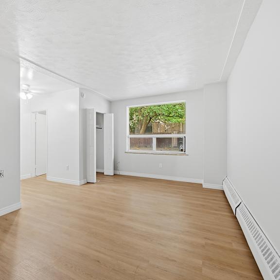 a room with wooden floors and white walls.
