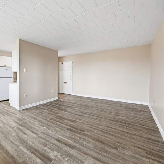 a room with a white ceiling and a wood floor.