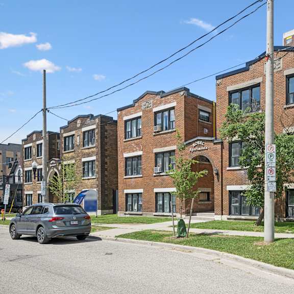 a street view of a residential area with a car parked on the side of the road.