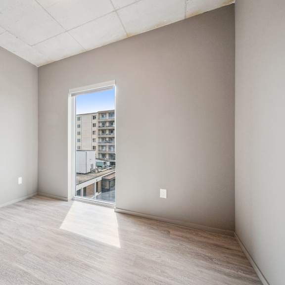 a room with a view of a building outside through a window.