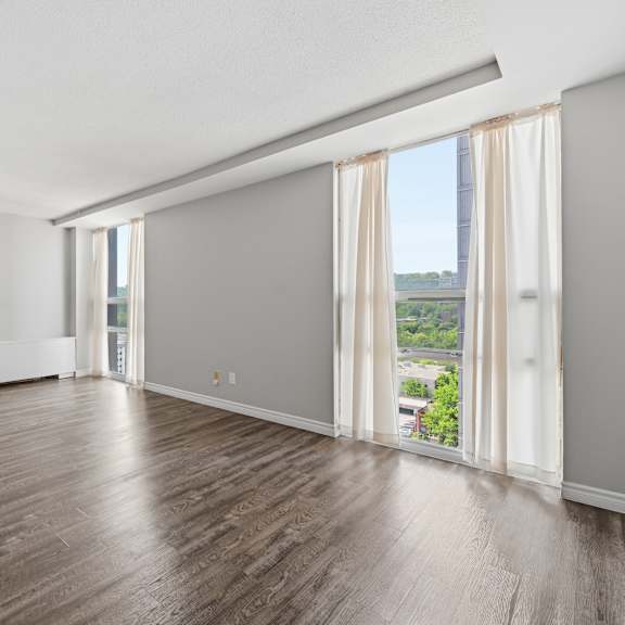 a large empty room with wooden floors and white walls.