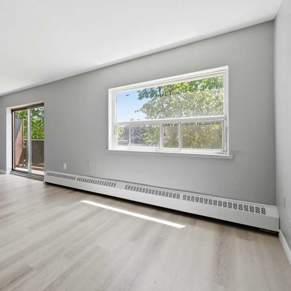 a room with a window and a sliding glass door.