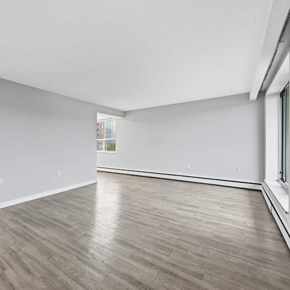 a room with wooden flooring and white walls.