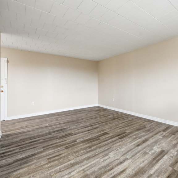 a room with wooden flooring and a white ceiling.