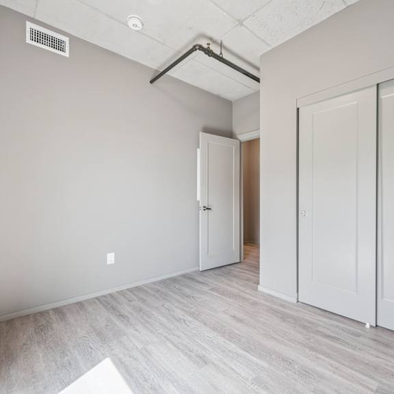 a room with a white door and a white cabinet.