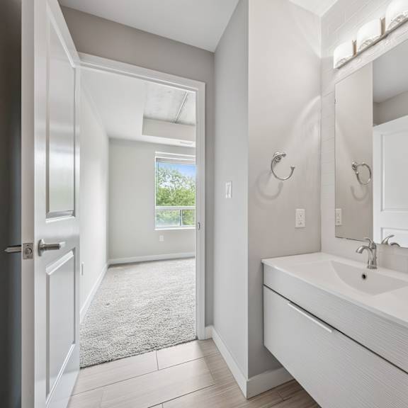 a bathroom with a white sink and a mirror.