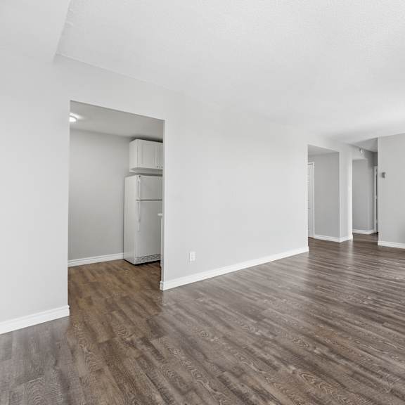 a room with wooden flooring and white walls.