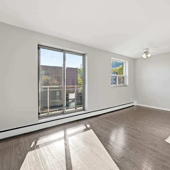 a room with a large window and a view of a building outside.