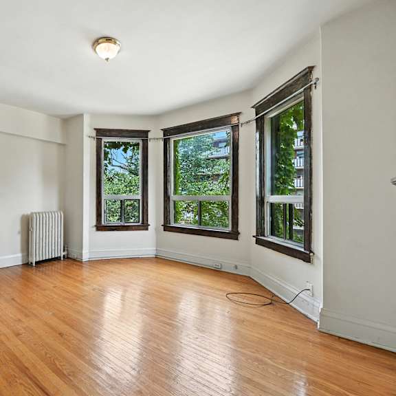 a room with wooden floors and white walls.