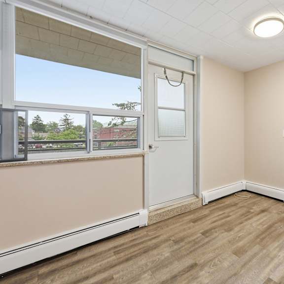 a room with a window and a sliding door.