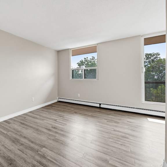 a room with wooden flooring and a window.